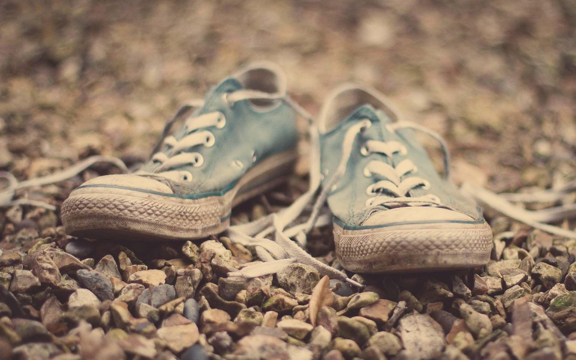 Old sneakers on gravel wallpaper and image