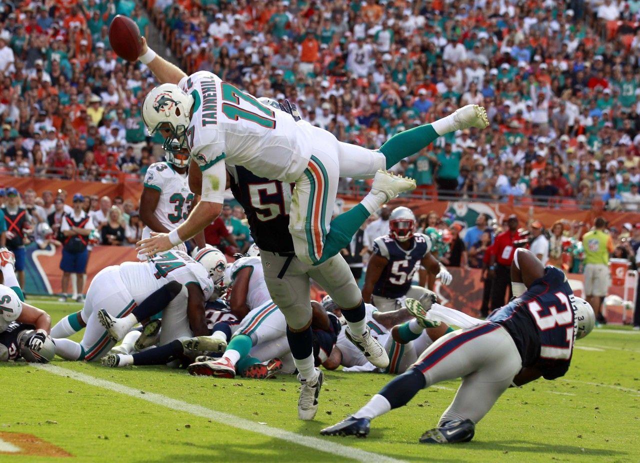 Miami Dolphins quarterback Ryan Tannehill leaps for a