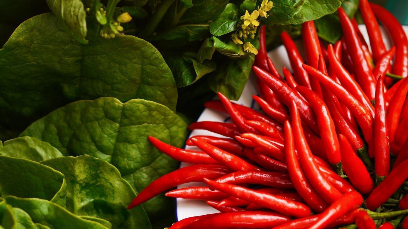 Red Chili Lot on Brown Wooden Table · Free Stock Photo