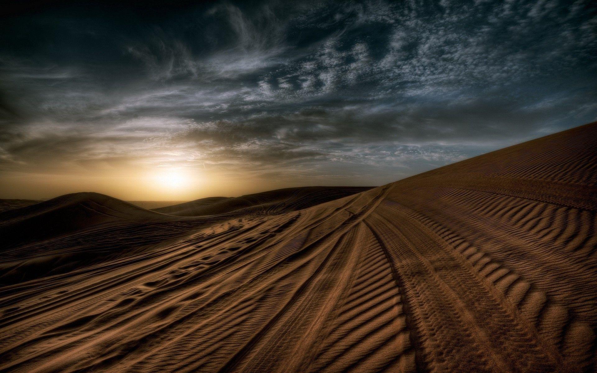 Tire tracks in the sand in the desert wallpaper and image
