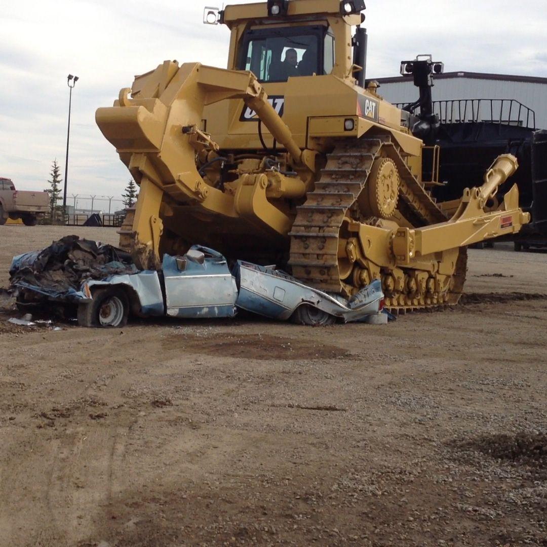 Caterpillar D11T bulldozer crushing a truck