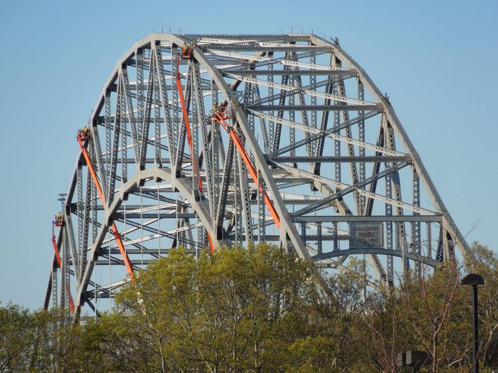 Four crews of steel workers on lifts above the Cape Cod Ca