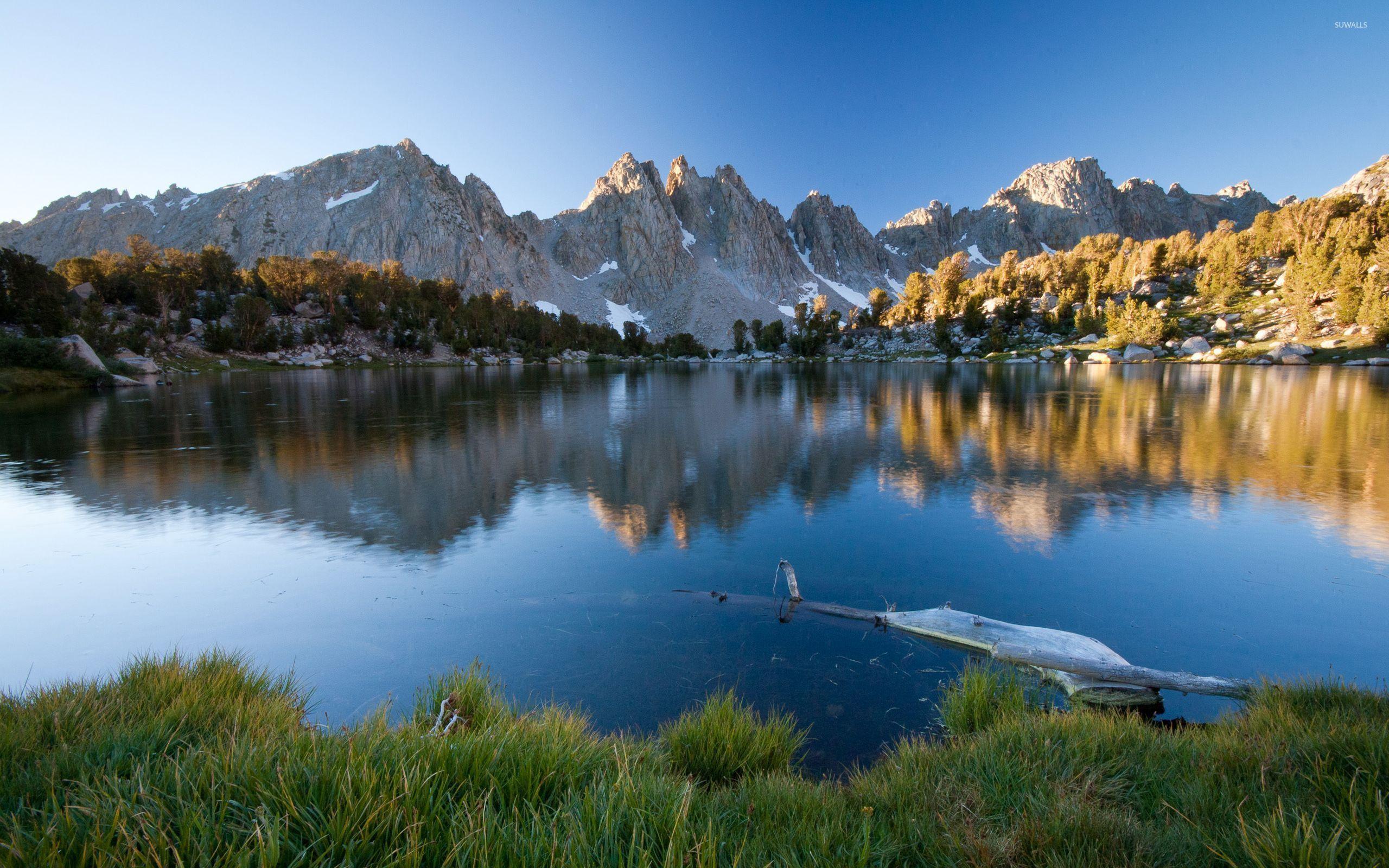 Sharp rocky peaks above the snowy mountains wallpaper