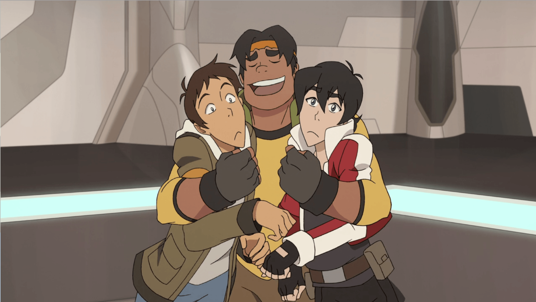 Hunk gives Lance and Keith a tight and loving hug from Voltron