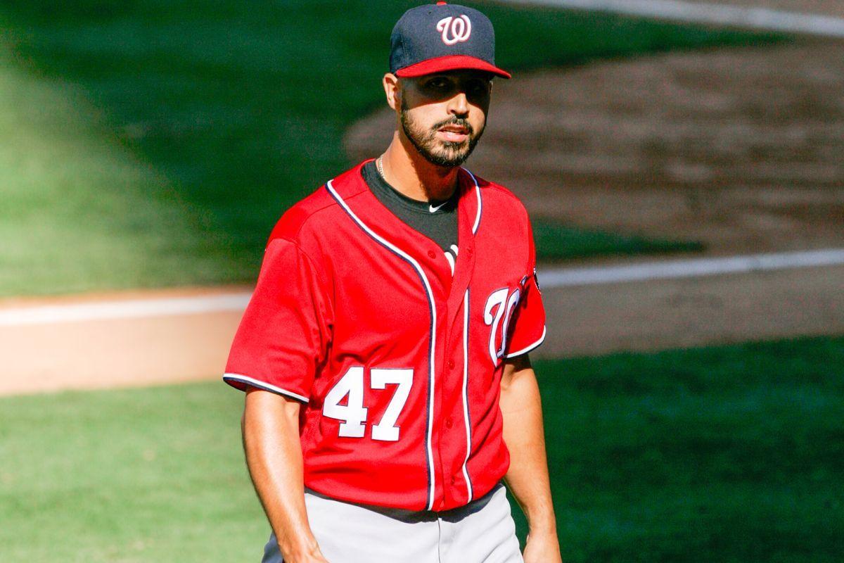 Washington Nationals' skipper Dusty Baker leans on Gio Gonzalez