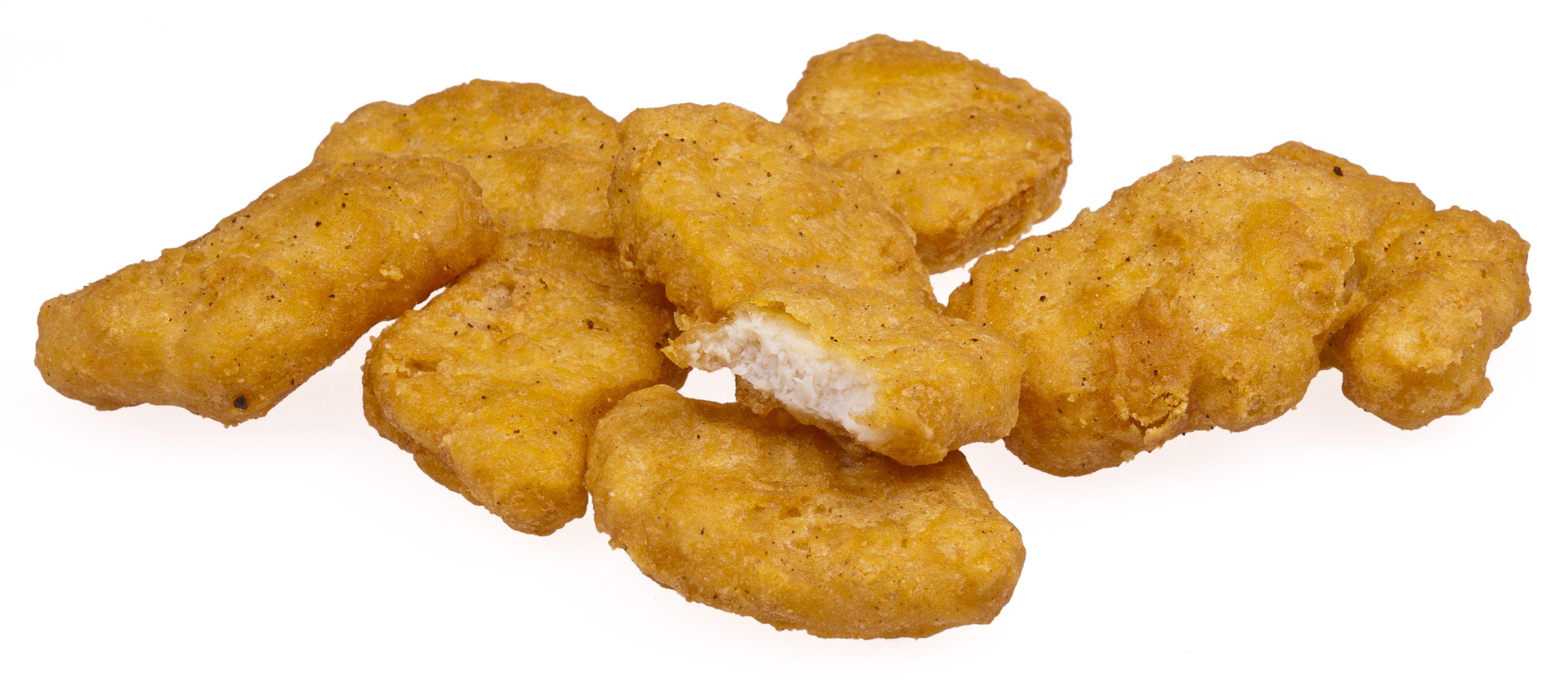 Download A Pile Of Fried Chicken Nuggets On A White Surface Wallpaper   Wallpaperscom