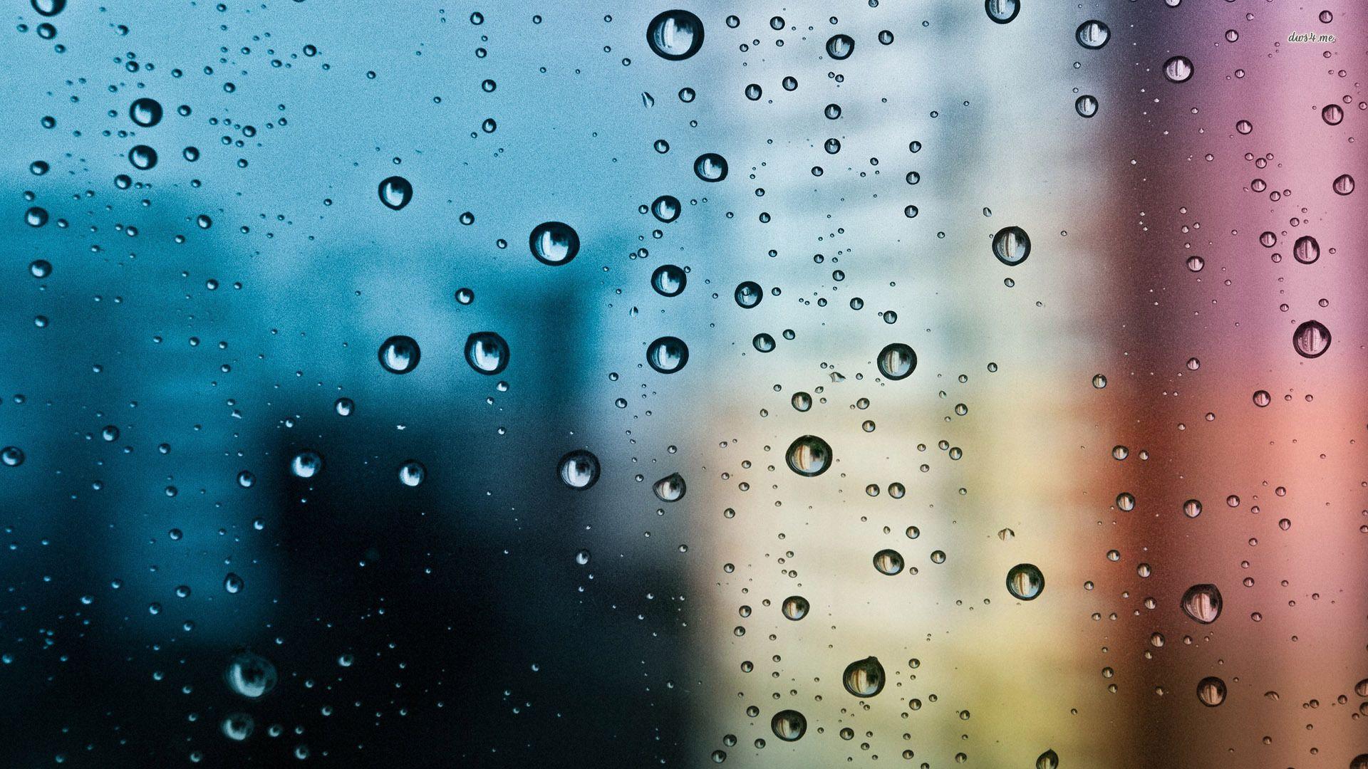Rain drops on the window blurred city background. Background