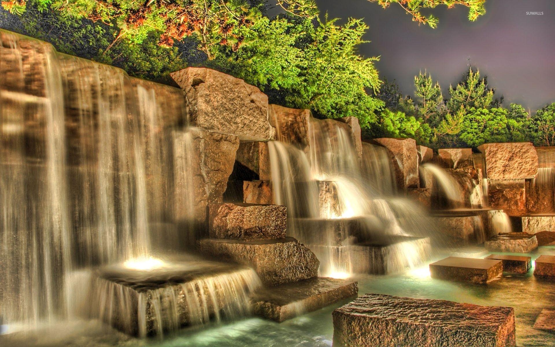 Artificial waterfall in a garden wallpaper wallpaper