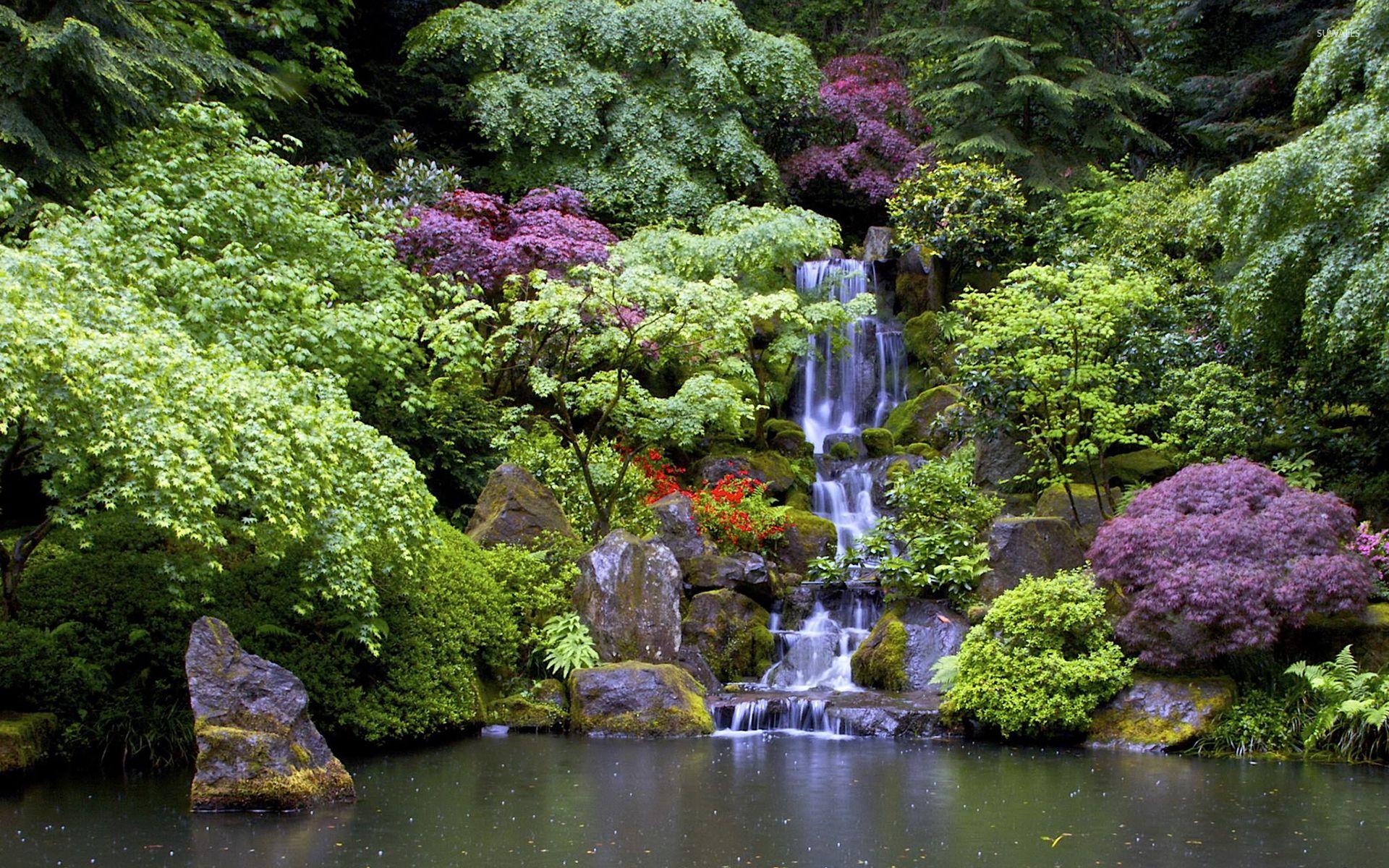 Artificial waterfall in the beautiful garden wallpaper