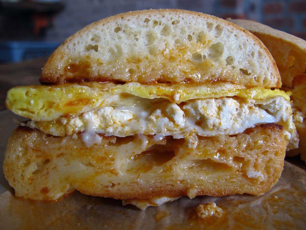 Egg Sandwich. Egg & Ricotta on pan de bono with maple hot s