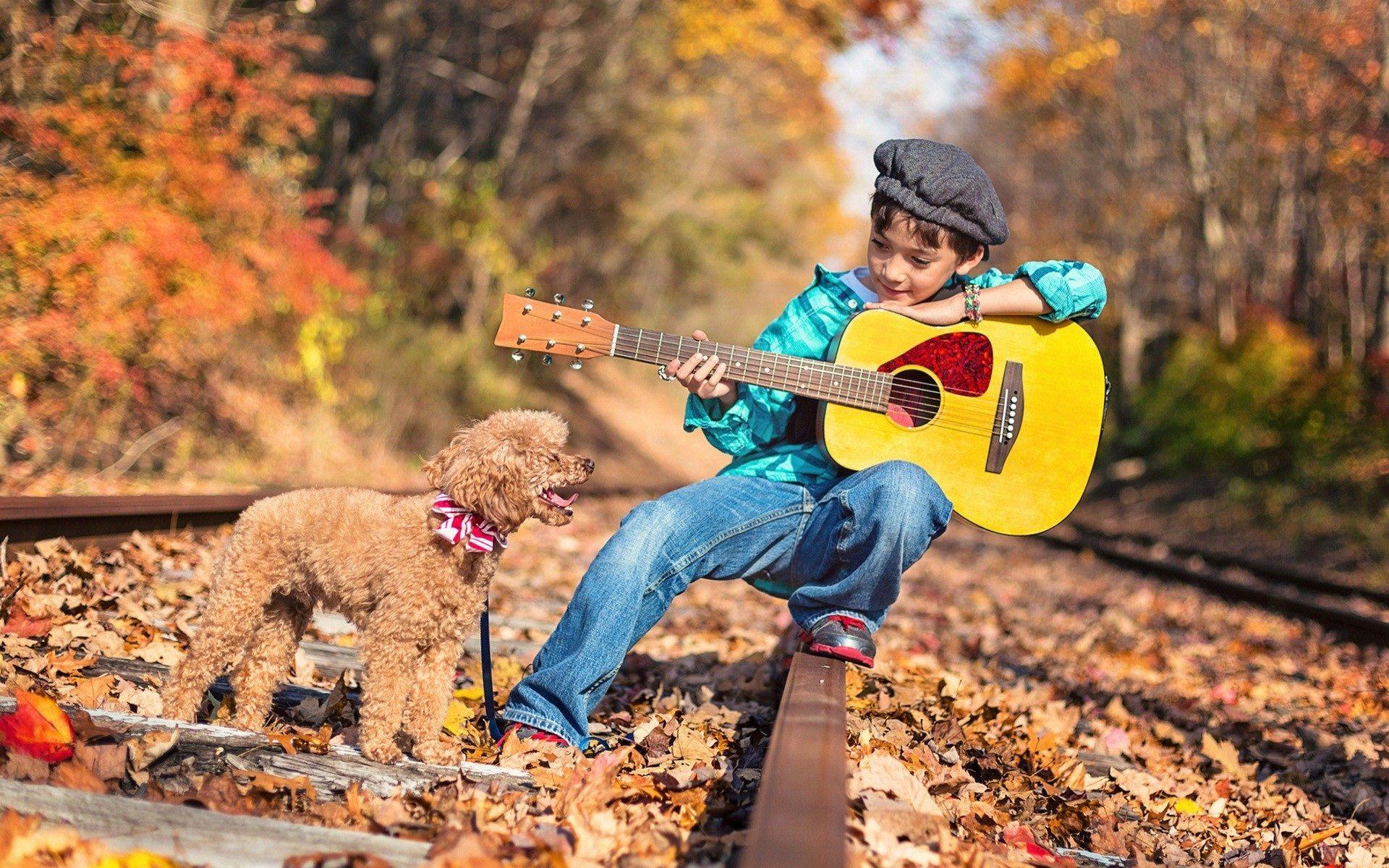 Small boy playing a guitar HD wallpaperNew HD wallpaper