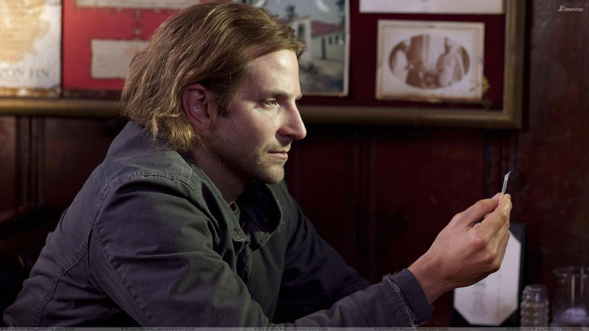 Bradley Cooper In Black Jacket Sitting Side Pose Photohoot Wallpaper
