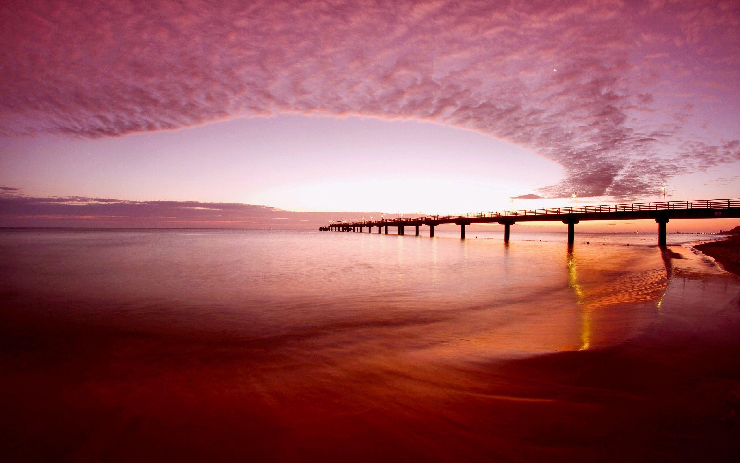 Pink sky over the beach wallpaperx1600