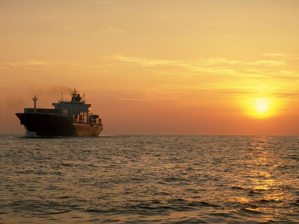 Container Ship sailing off the sunset. Commercial