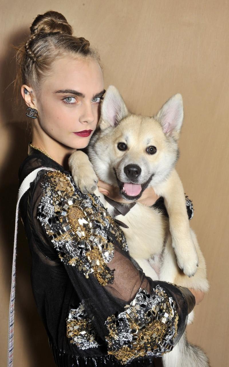Cara Delevingne brings her dog Leo to the front row at Chanel