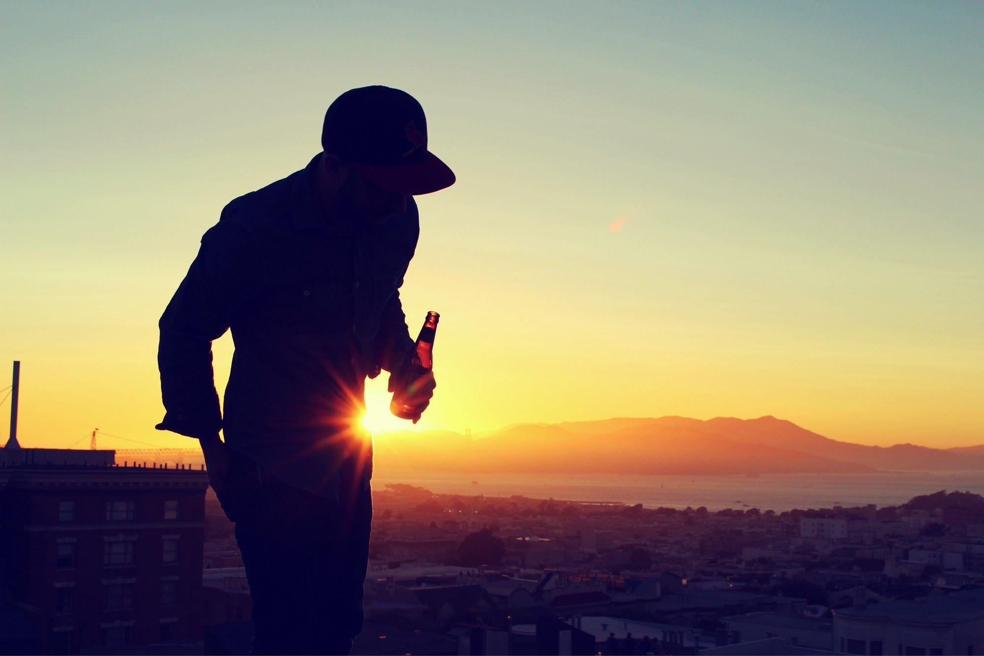 A man with a beer on the roof wallpaper and image