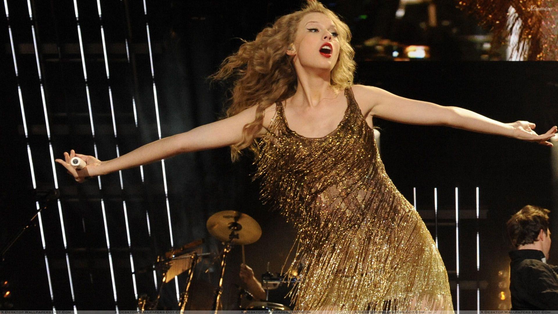 Taylor Swift In Golden Dress Singing A Song Wallpaper