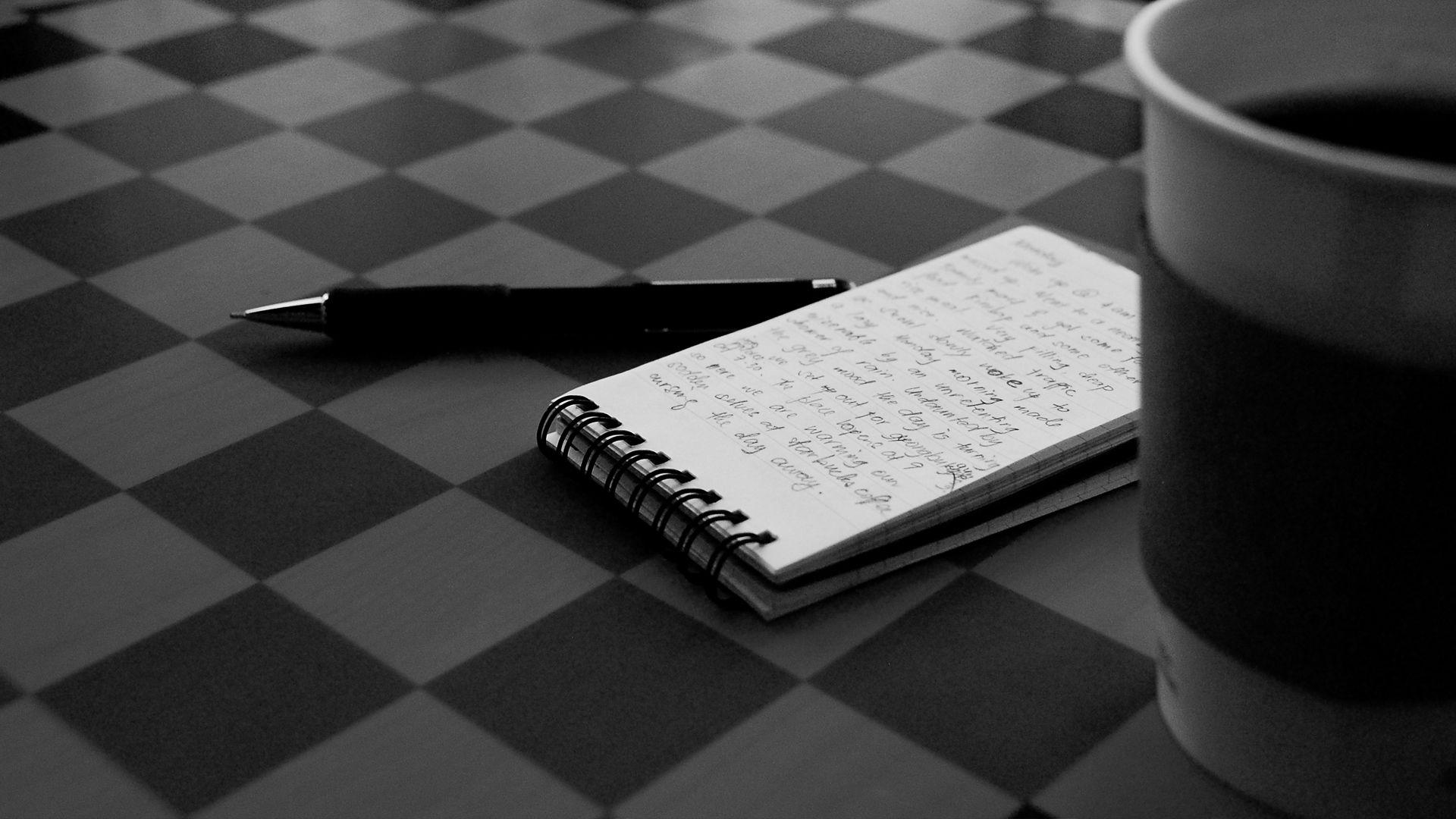 Black Desk Pen and Notepad Wallpaper