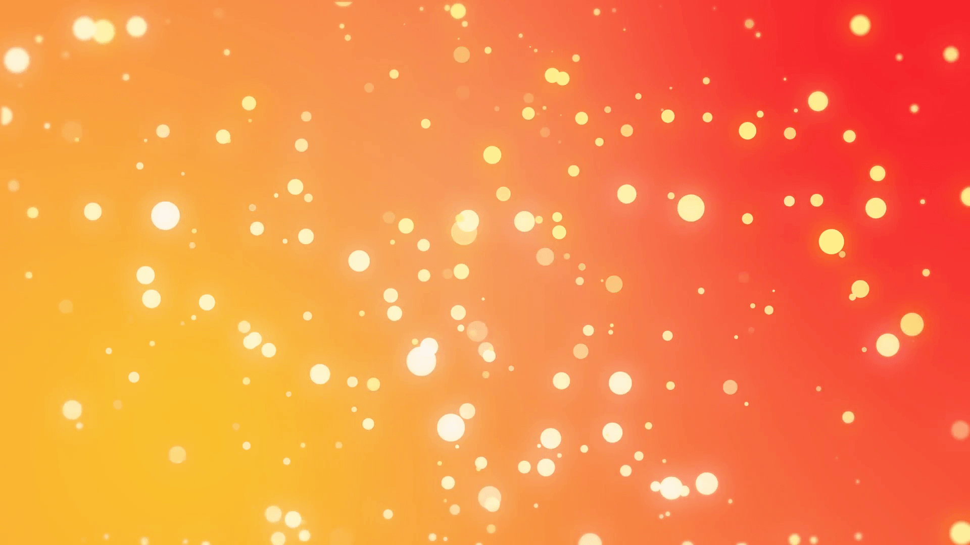 Sparkly light particles moving across a yellow orange red gradient