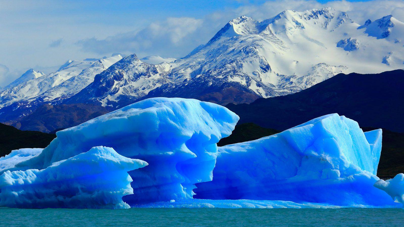 Explore ice blue glaciers that merge with the sky