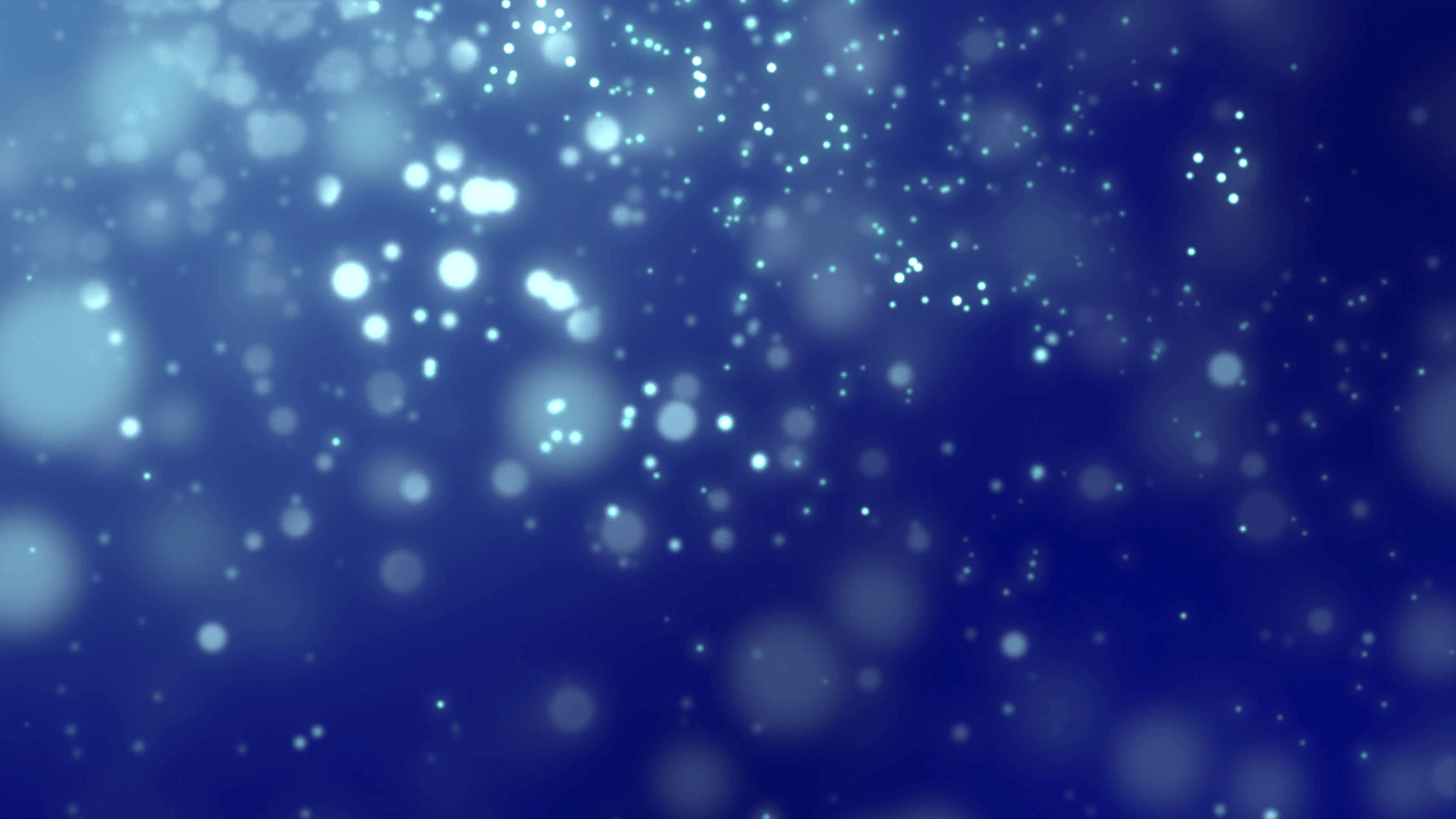 White luminous particles falling against dark blue background Motion