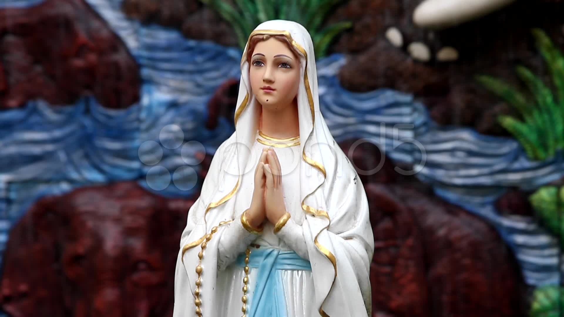 A praying virgin mary statue with fountain Hi Res