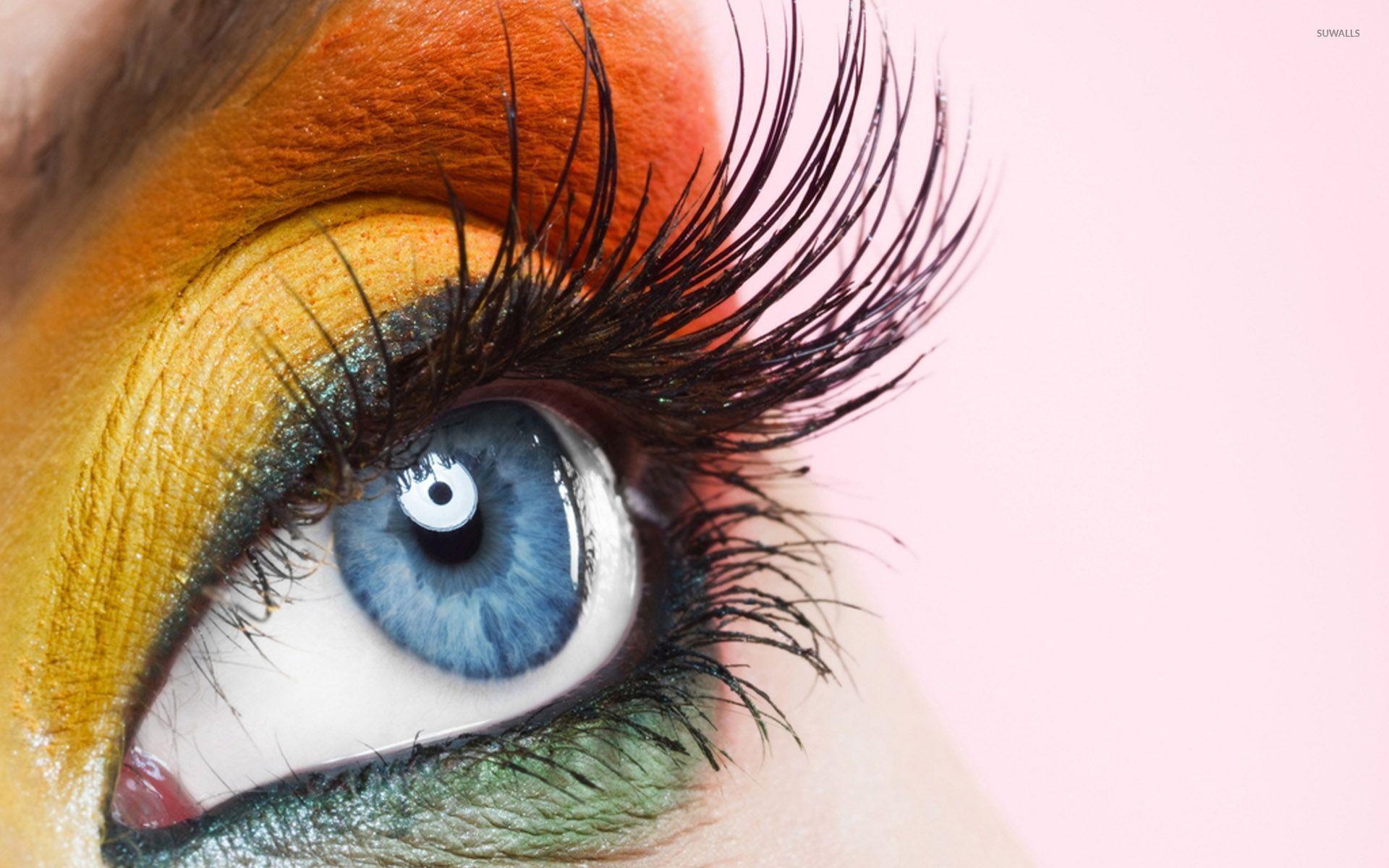 Orange and yellow makeup on the blue eyes wallpaper