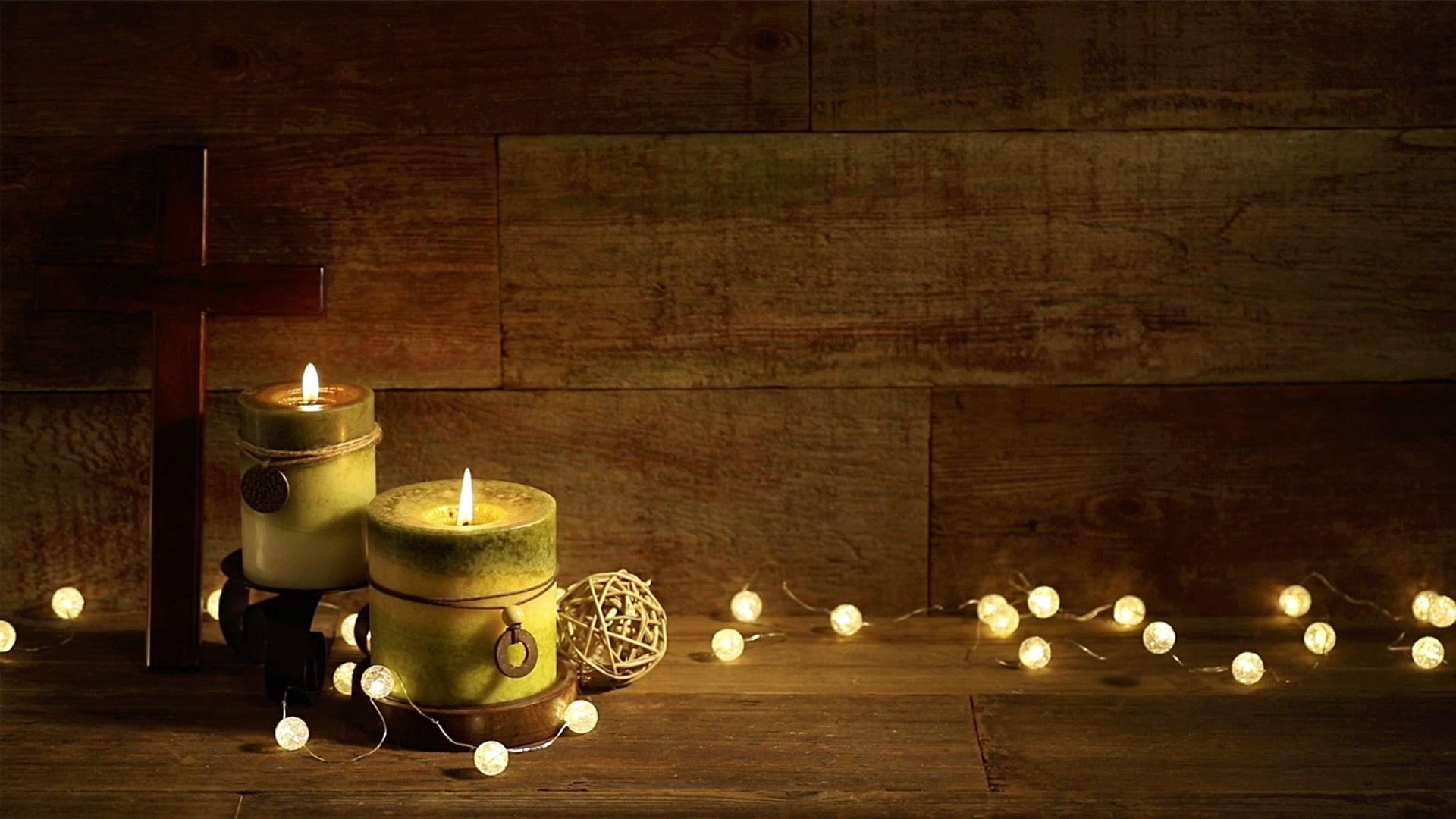 Candles and Cross with Christmas Lights on Wood Background Loop