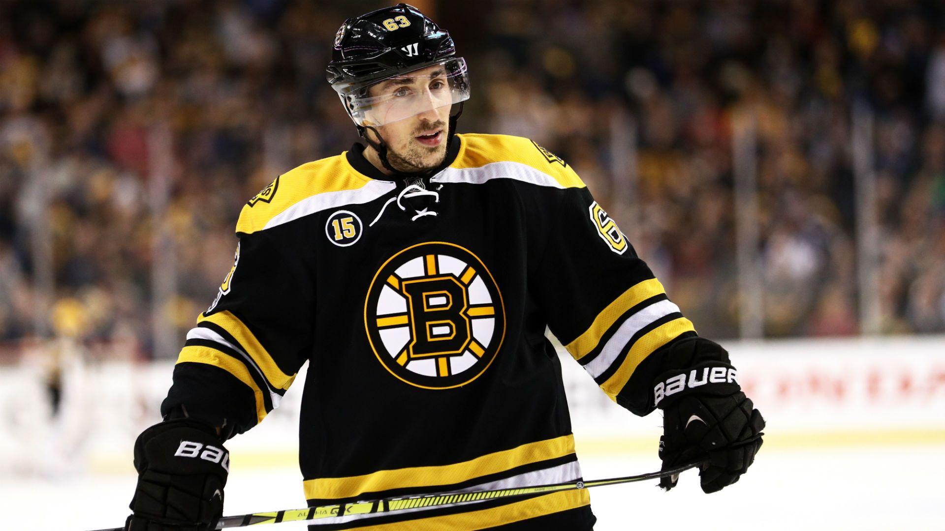 Bruins' Marchand leaves first period after hit, returns to score