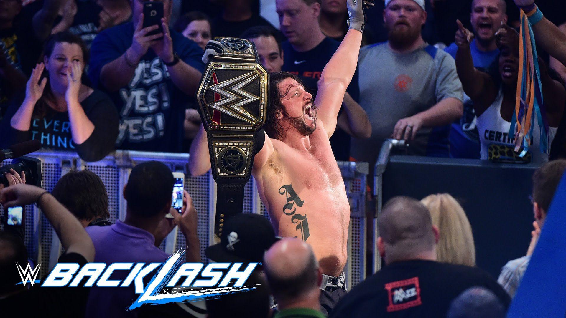 AJ Styles raises his hands high as the new WWE World Champion