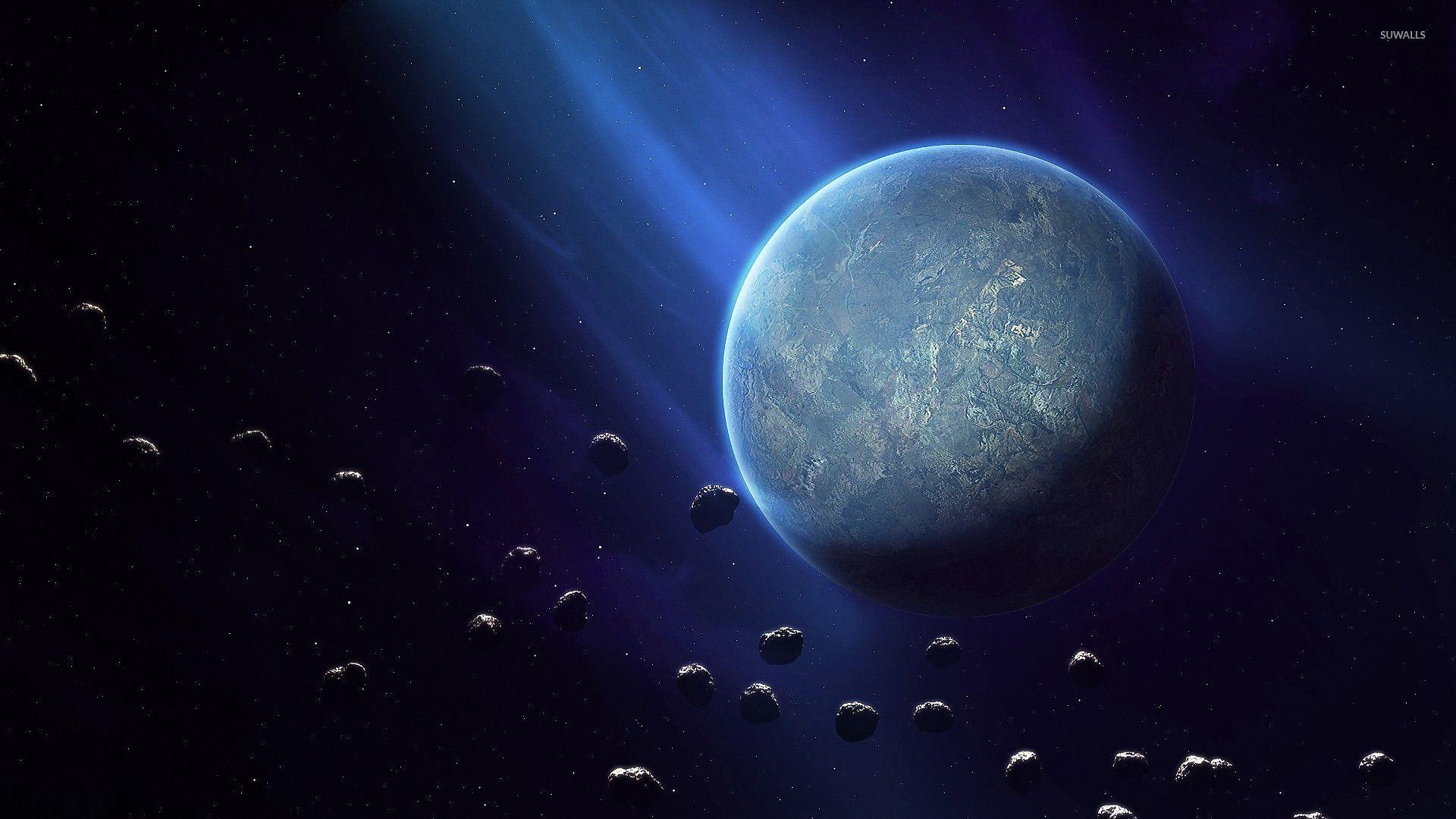 Planet surrounded by asteroids wallpaper wallpaper