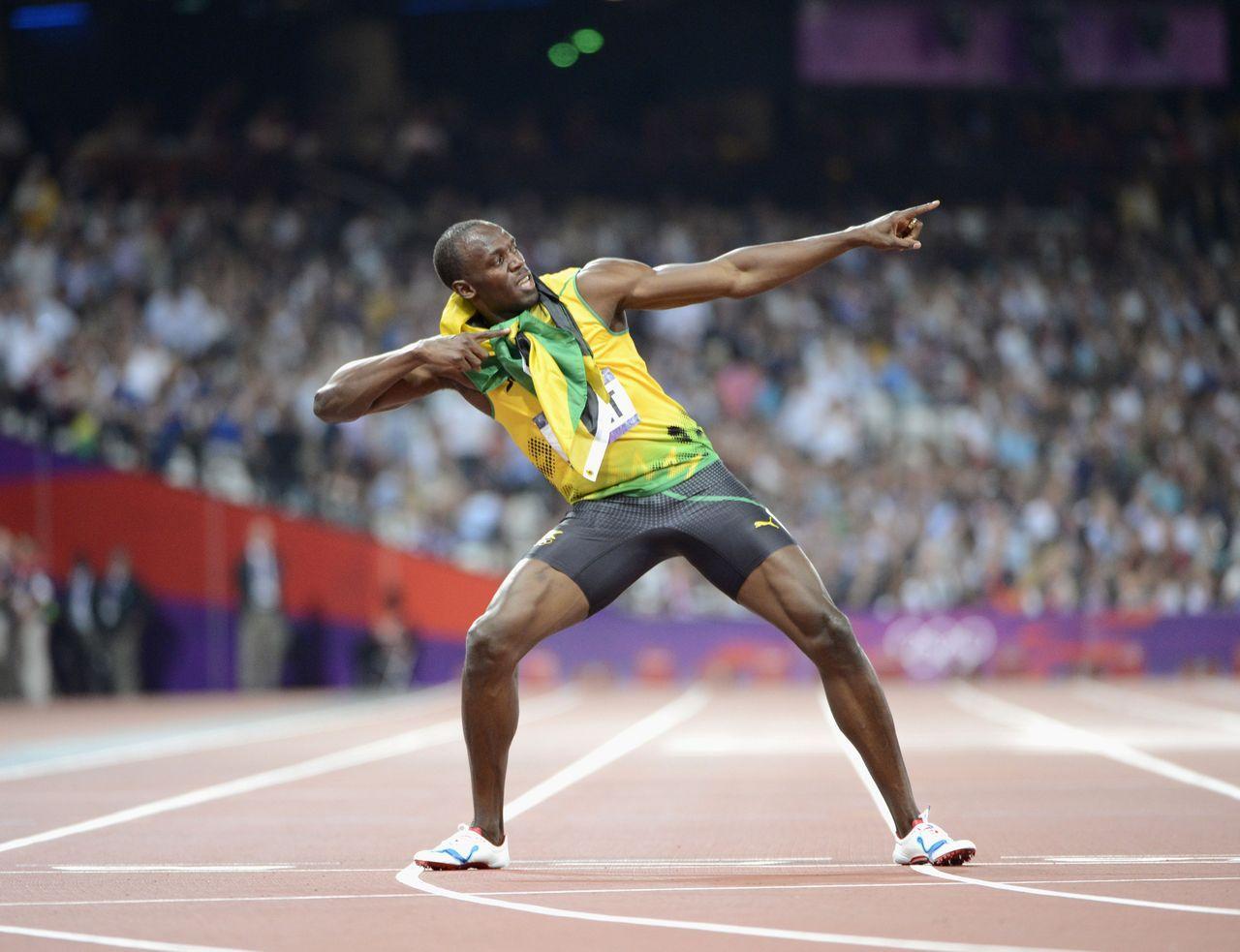 Download Usain Bolt Striking Pose Crowd Watches Wallpaper | Wallpapers.com