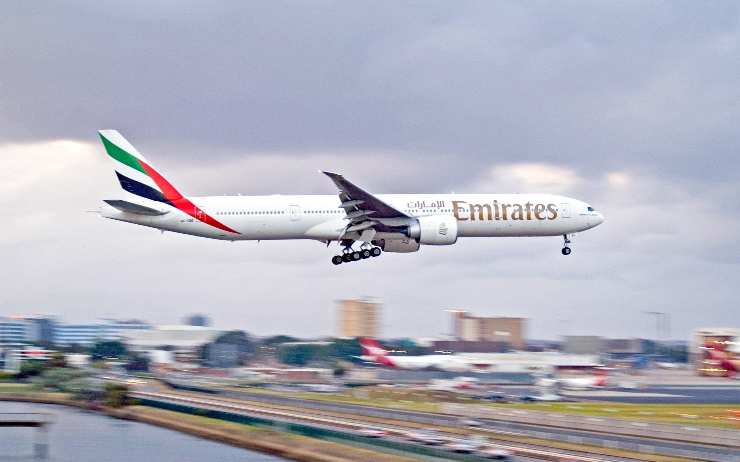 White Emirates Airplane landing during daytime HD wallpaper