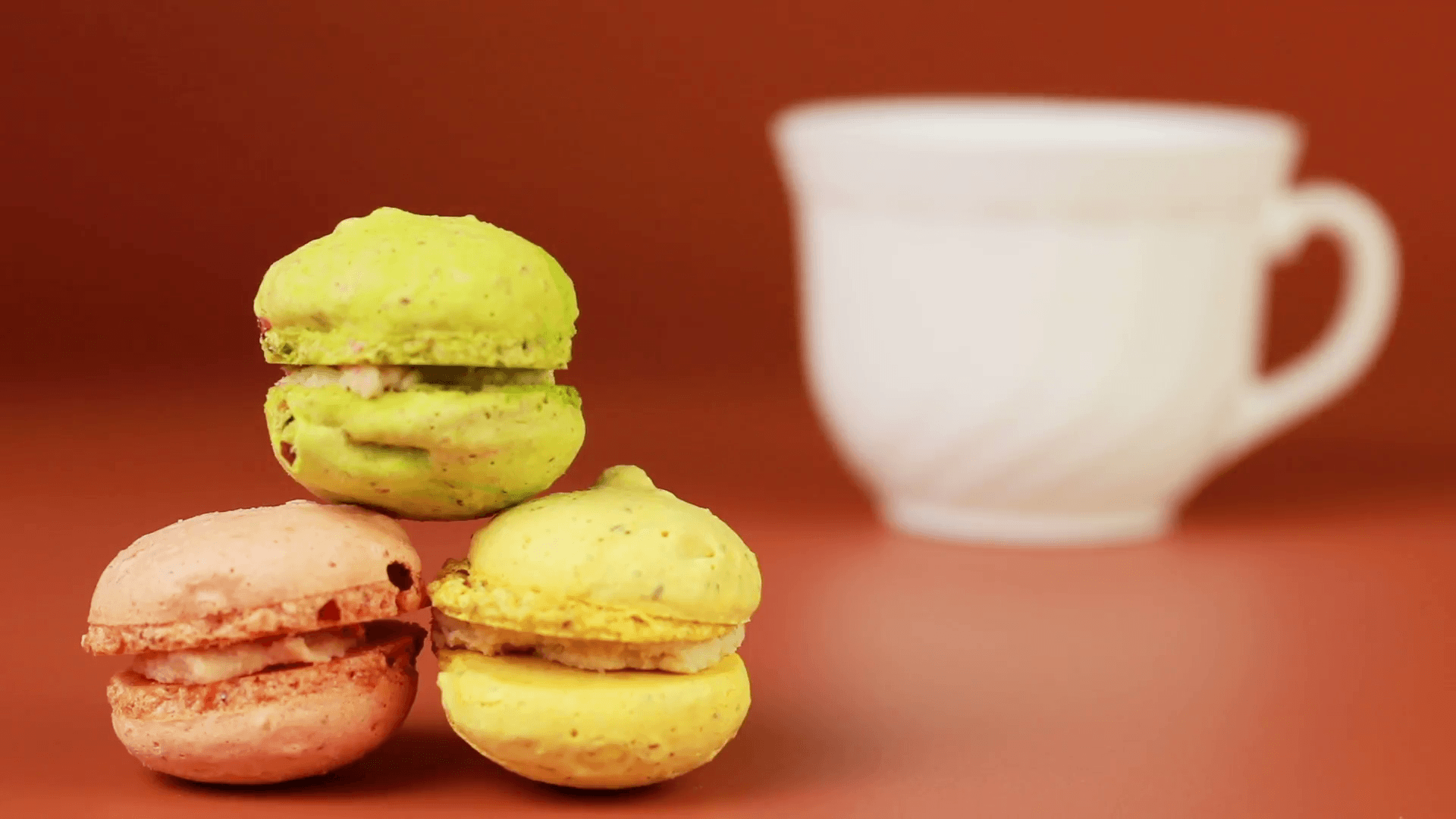 Cup of coffee with macaroons on a brown background. Stock Video