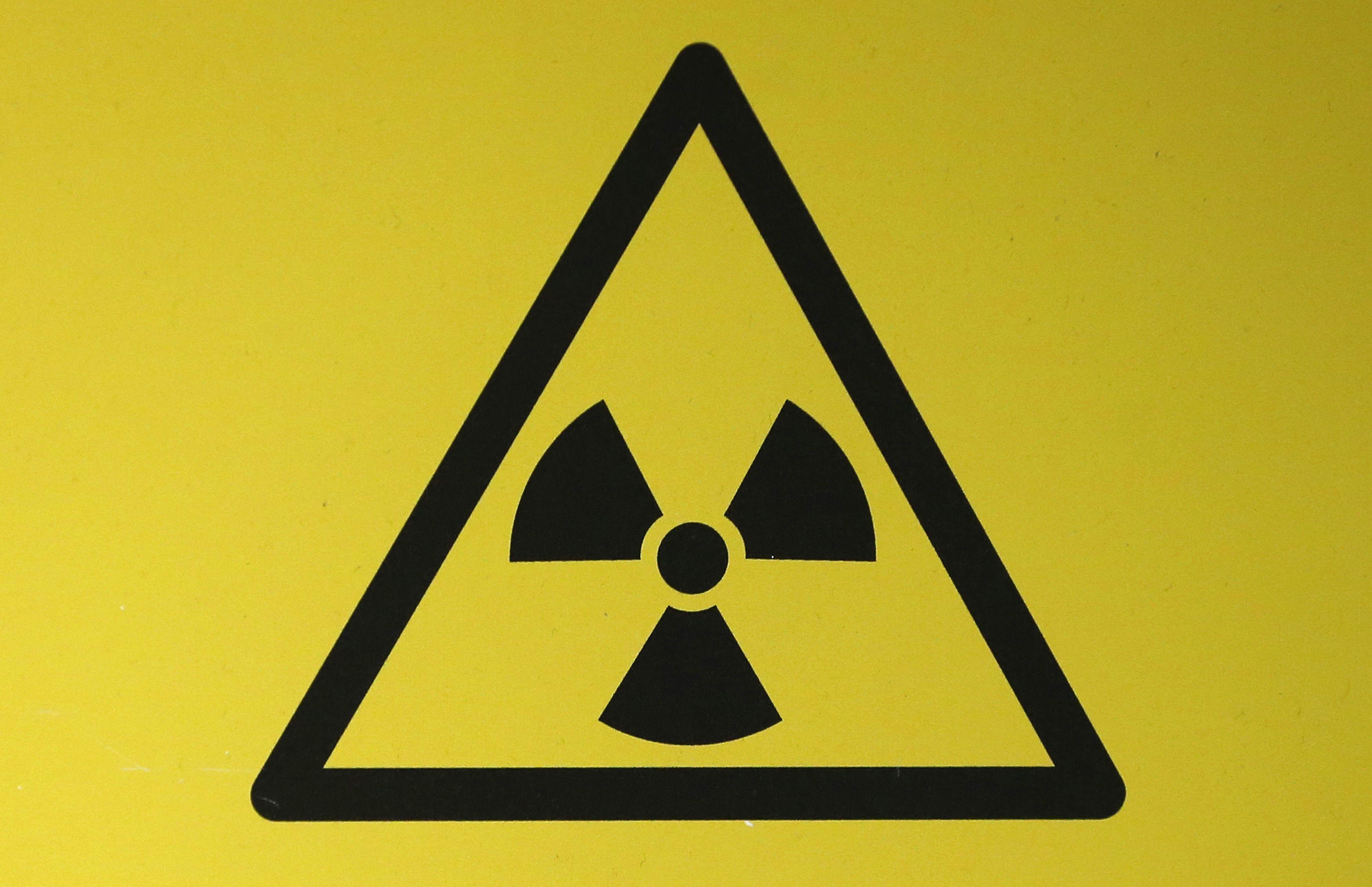 A RADIOACTIVE MATERIAL HAZARD SYMBOL, CALLED A TREFOIL, IS SEEN
