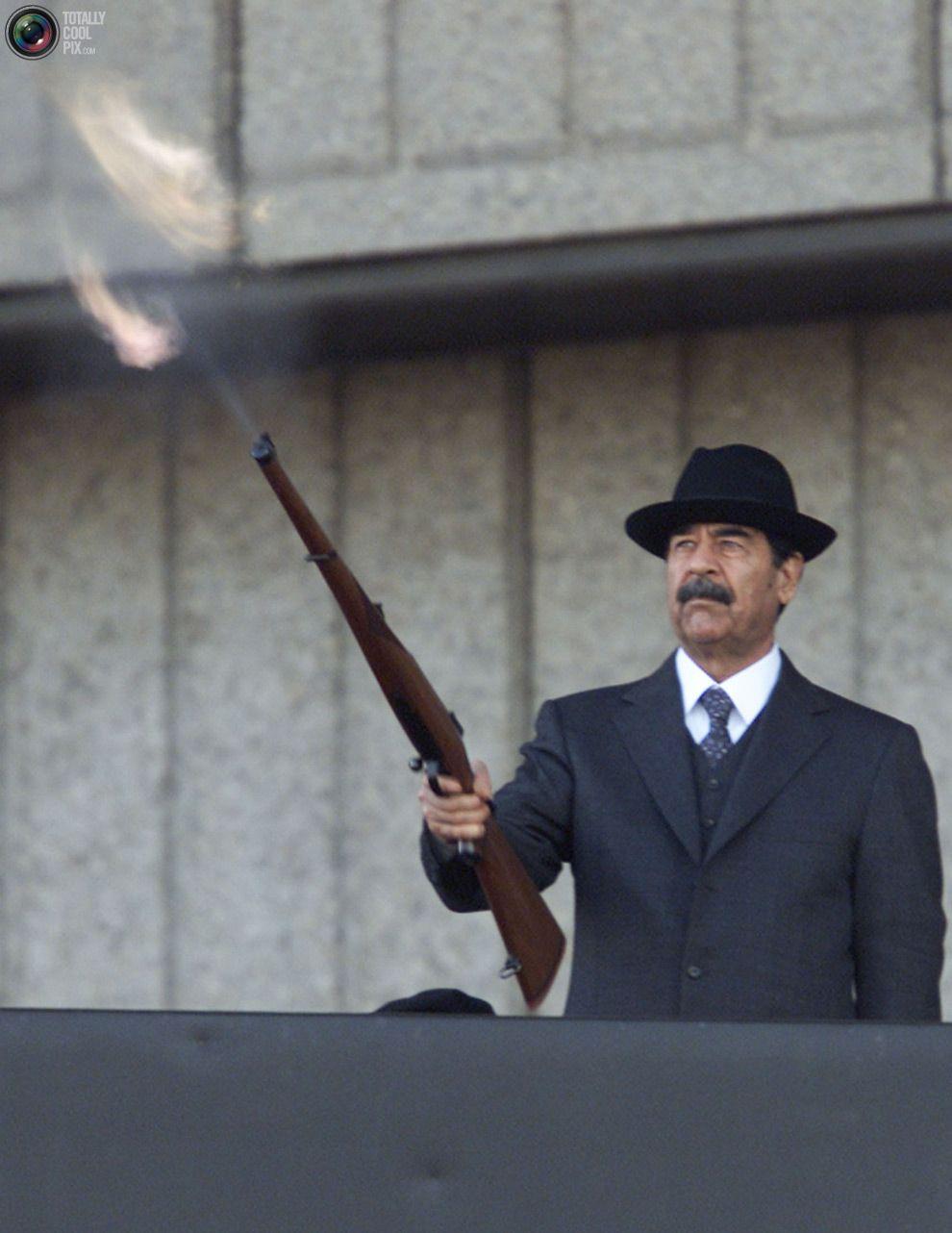 Iraqi President Saddam Hussein fires shots into the air on December