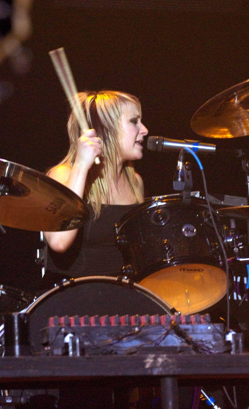 Photography. Jen Ledger of the band Skillet singing and playing