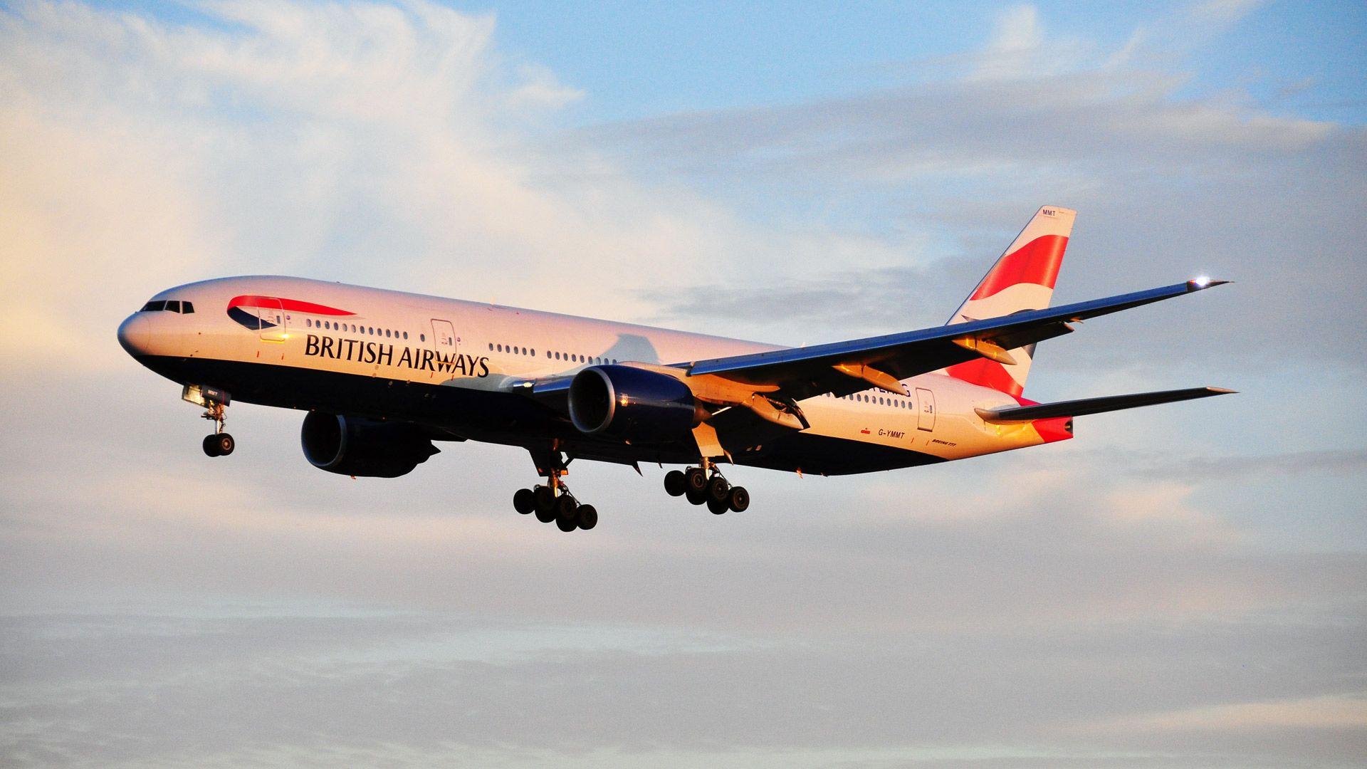 Boeing 777 of British Airways is flying at sunrise wallpaper