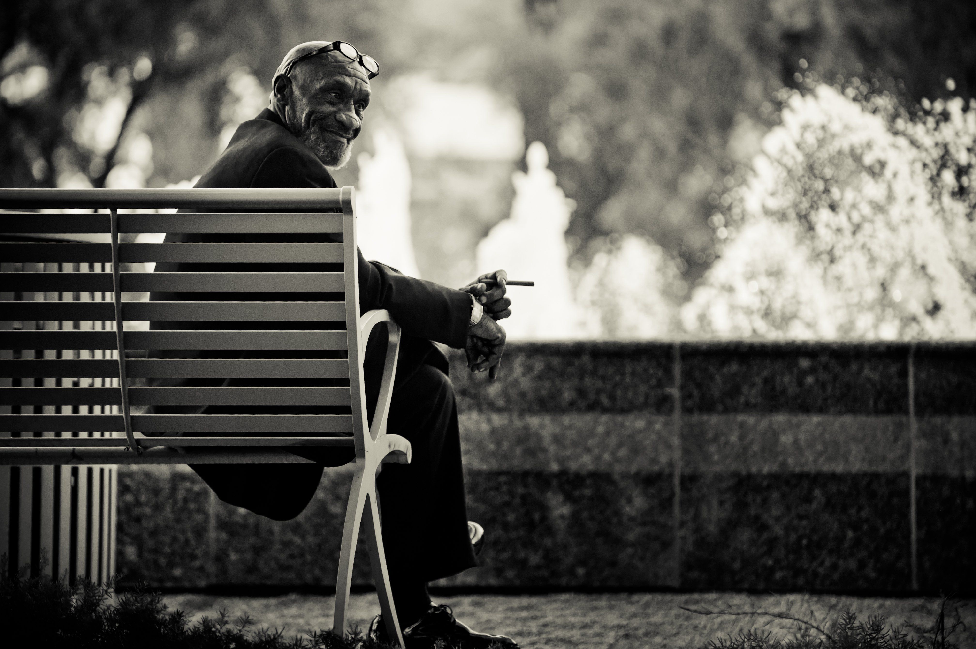 Charles Siritho man bench glasses cigarette clock mood portrait