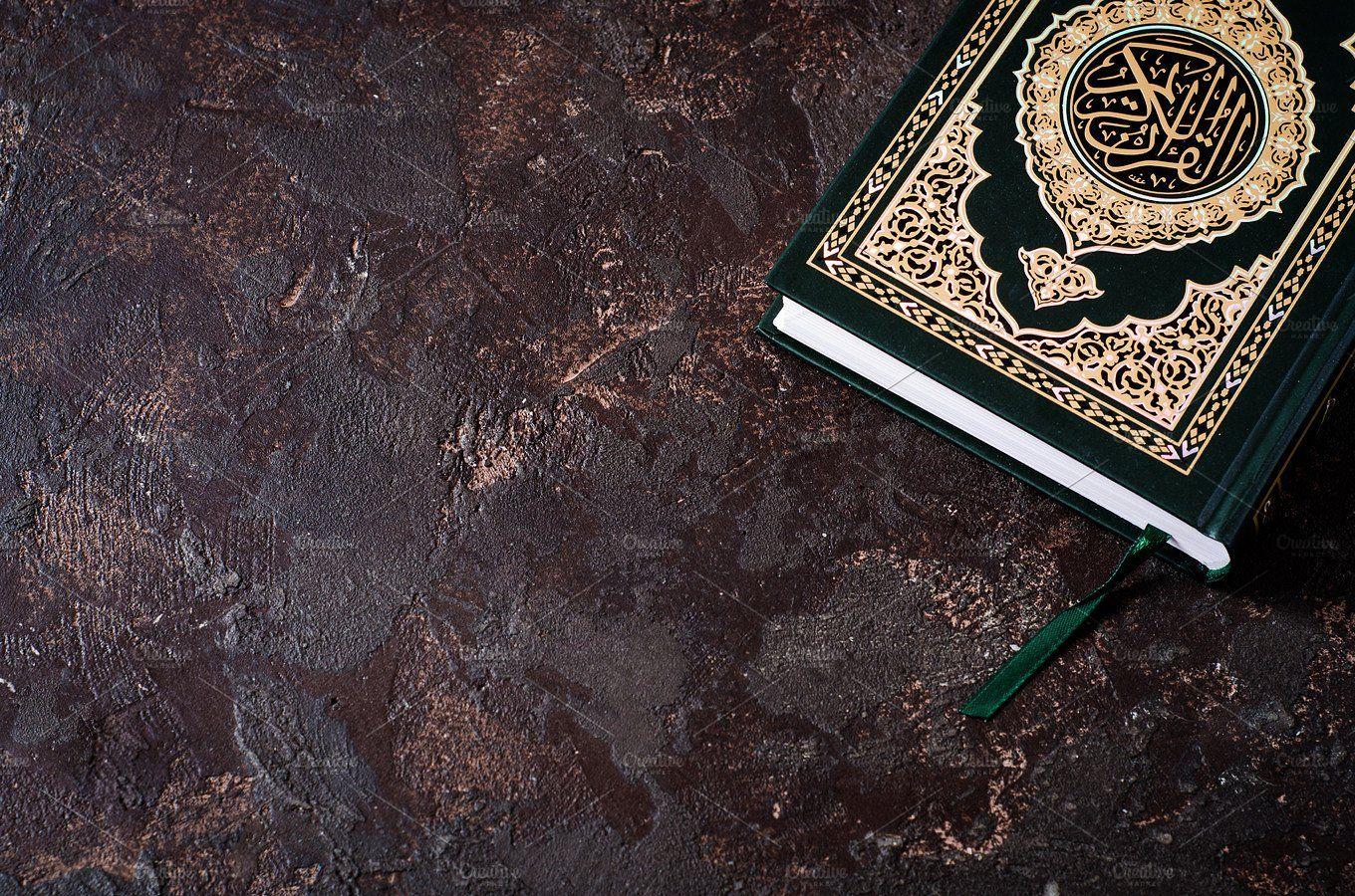 Islamic Book Koran and readpen on dark vintage background