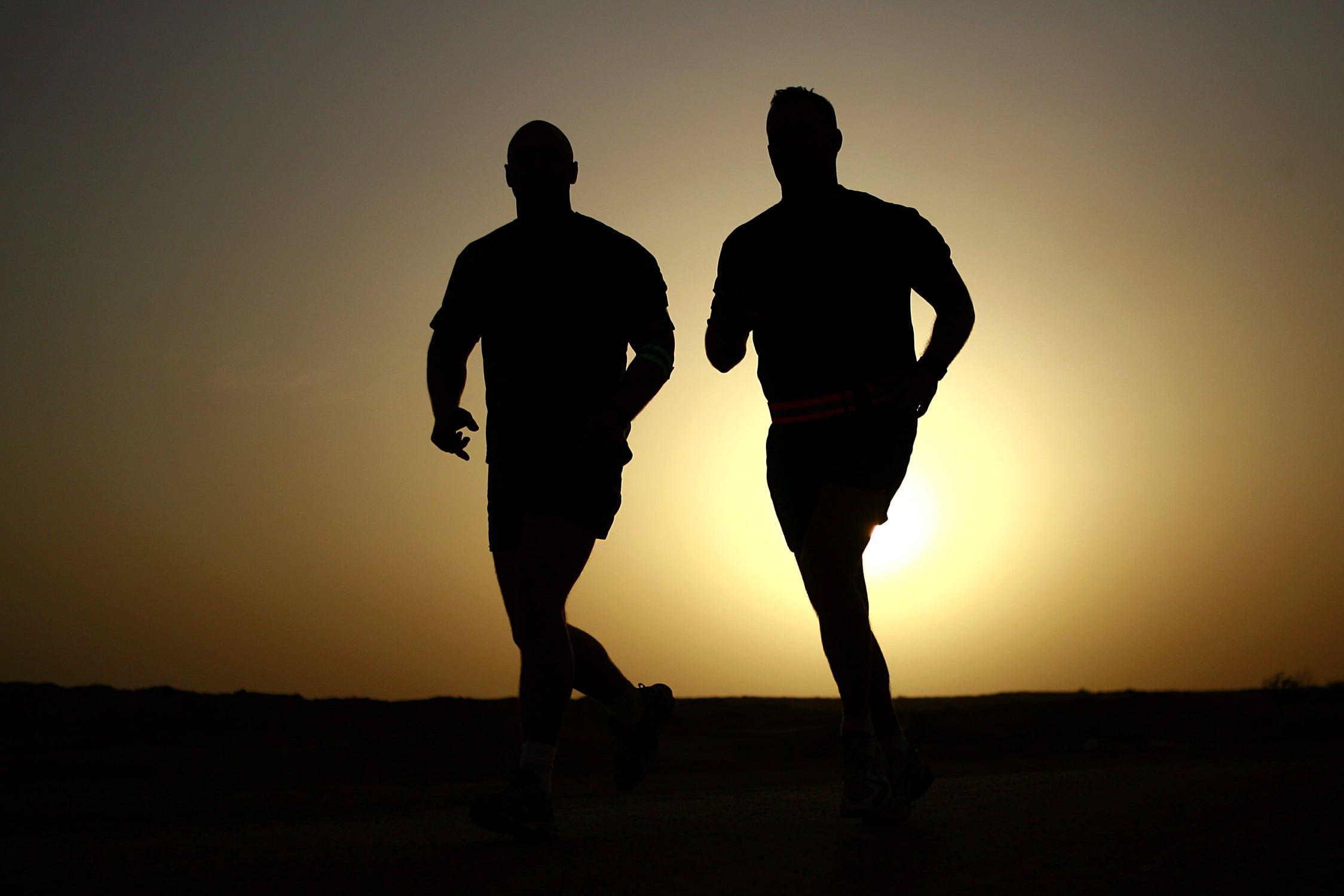 Silhouette of two man jogging during golden hour HD wallpaper