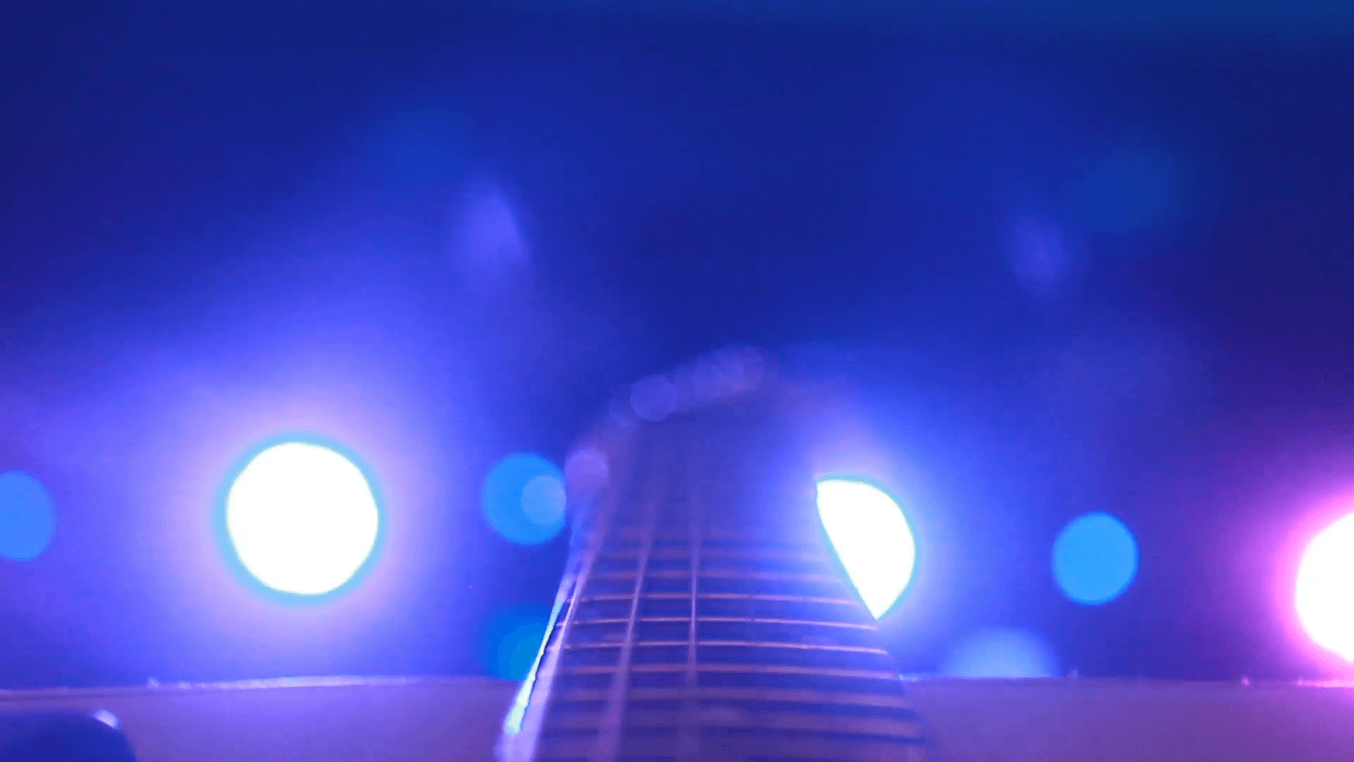 rock concert: backstage: guitar on the background of stage lighting