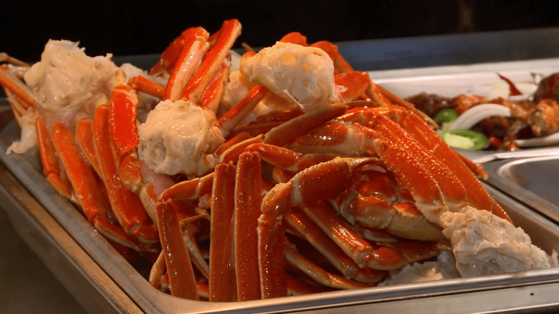 Crab Legs in a pan are served hot and steaming at a Chinese
