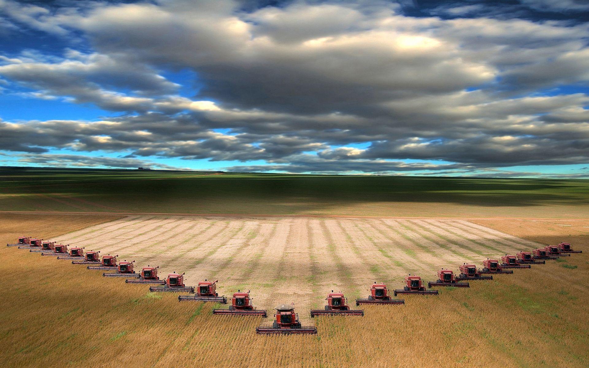 Combines harvesting wheat in I believe North Dakota. Harvest time
