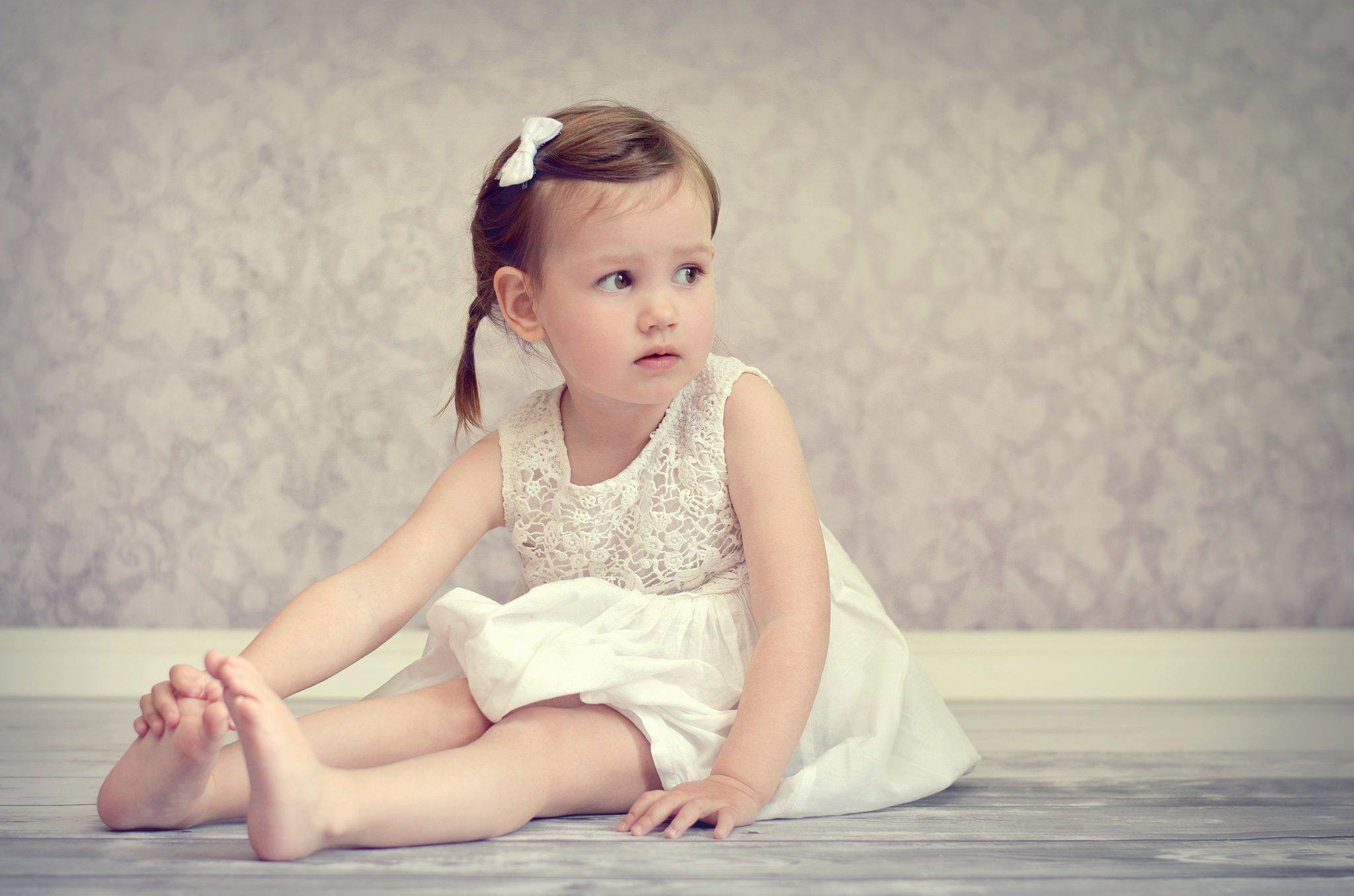 Mood Girl Dress Baby Floor Sitting Barefoot High Resolution Image
