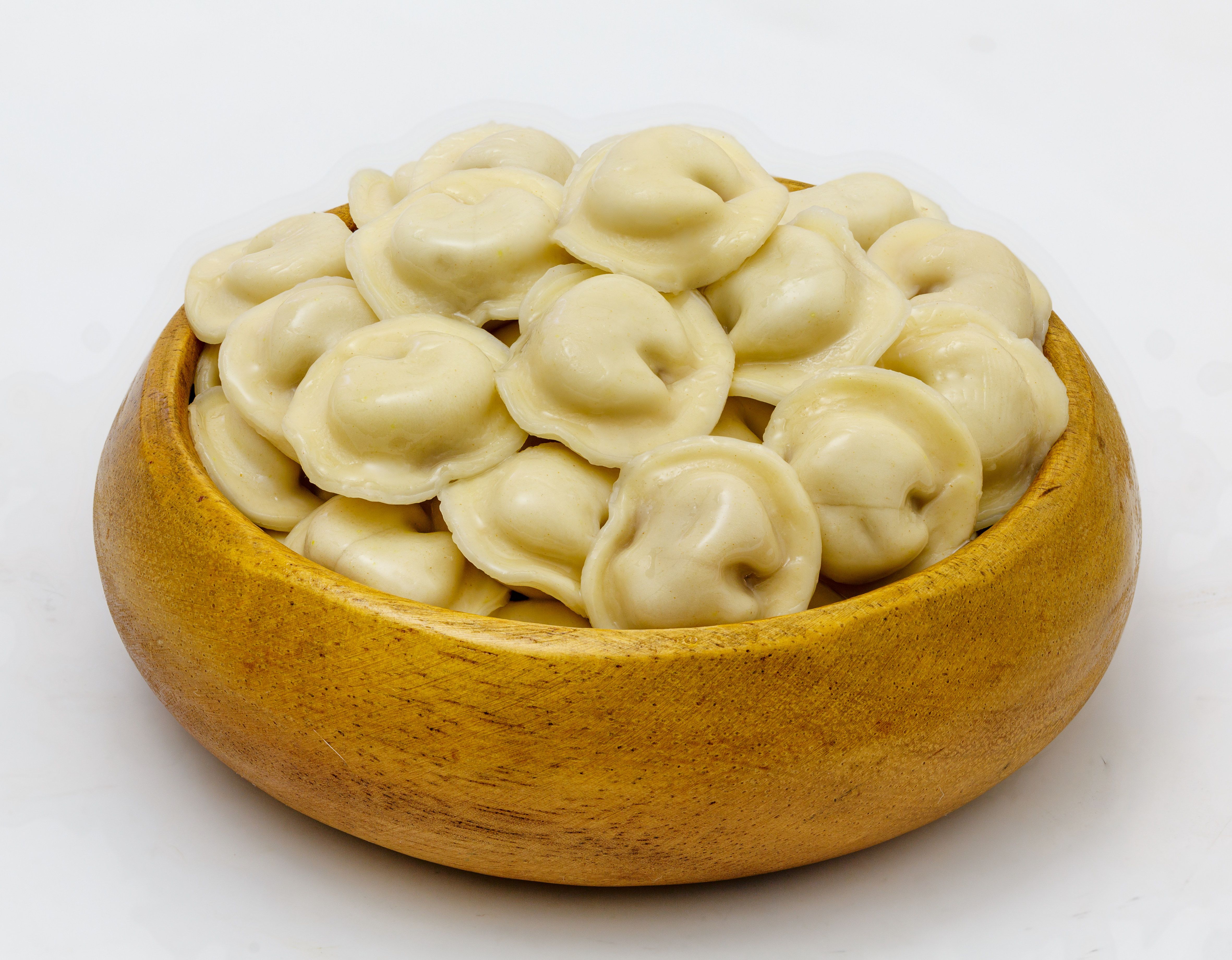 Appetizing dumplings in a wooden bowl on a gray background