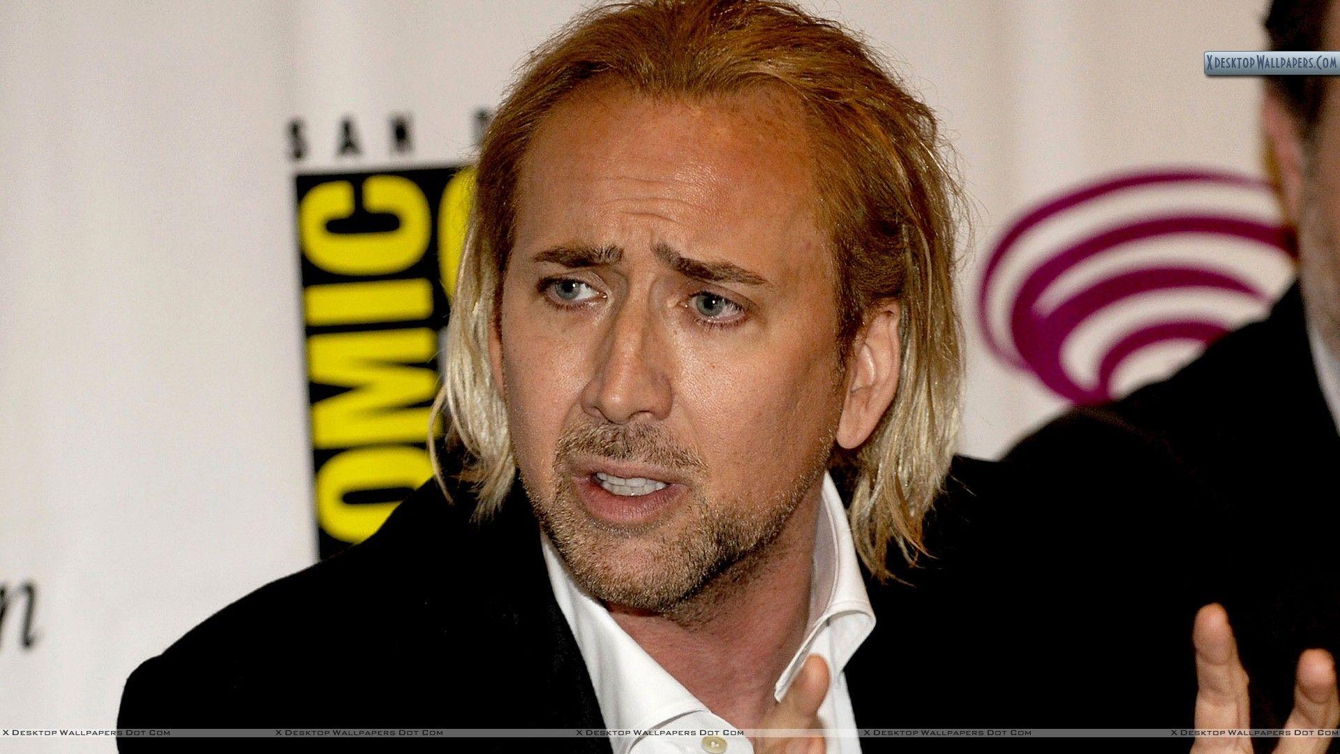 Nicolas Cage Looking Side In Black Coat Wallpaper