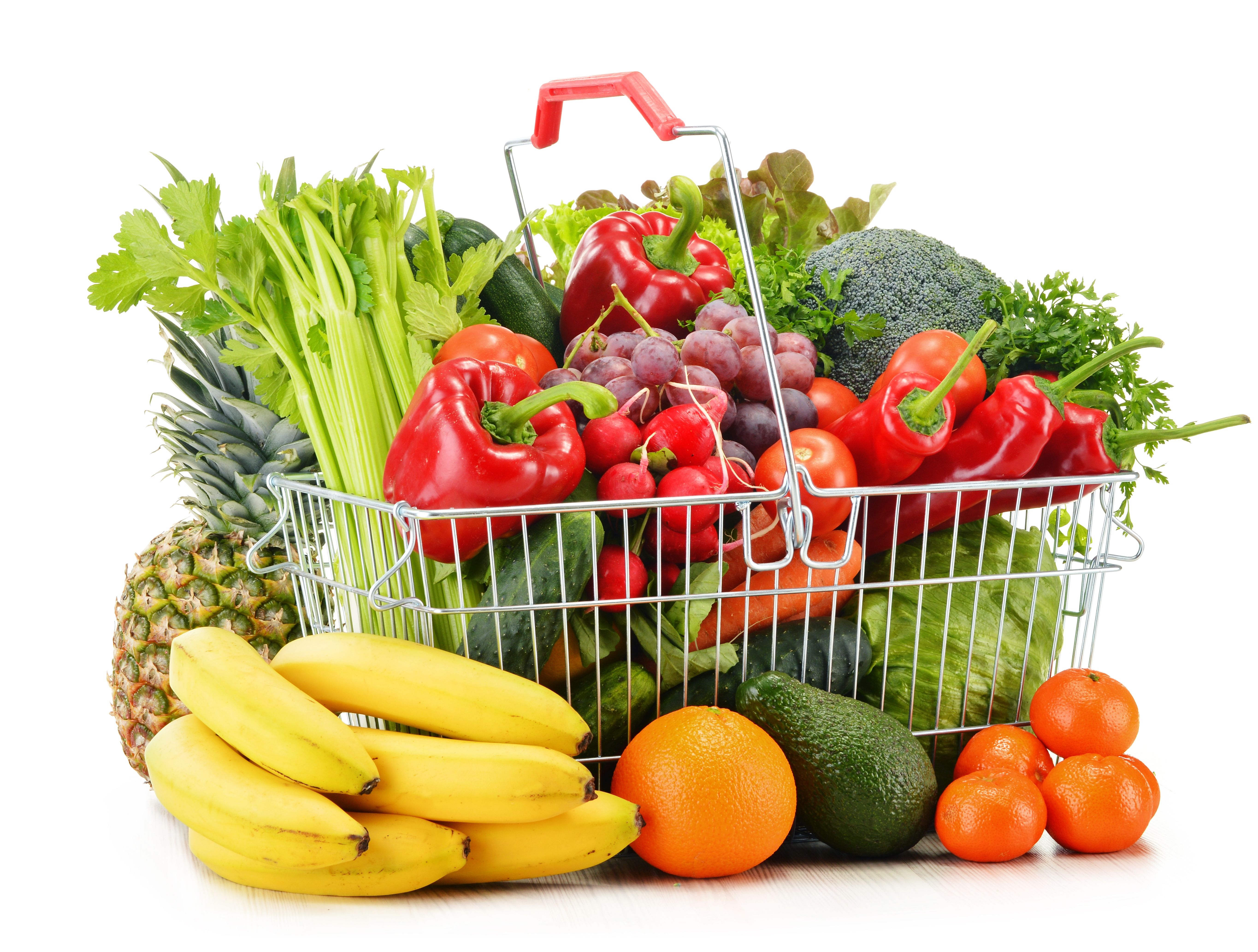 Iron basket with fresh vegetables and fruits on a white background