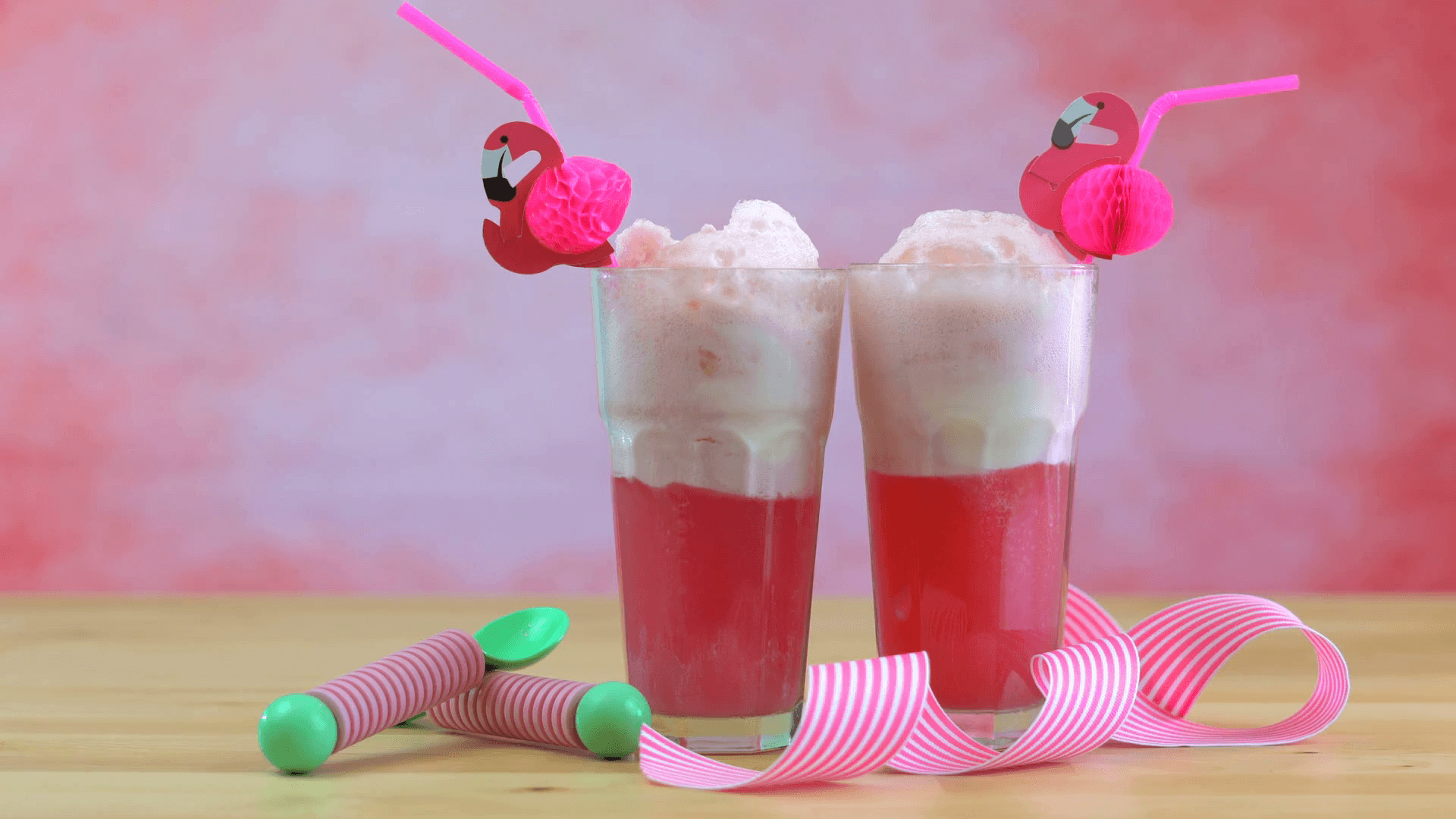 Making ice cream soda floats with pink raspberry soda and ice cream