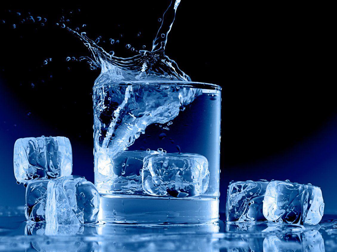 Water in a glass full with ice cubes
